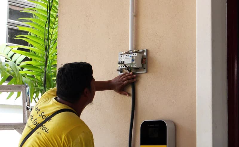 ChargeSingh installer working on EV charger