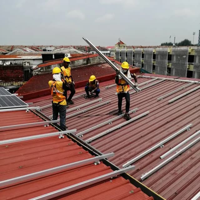 Workers installing solar panels